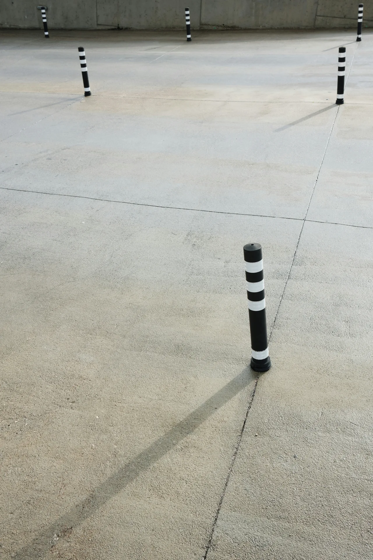 broom-finished concrete parking lot with bollards in Abbotsford