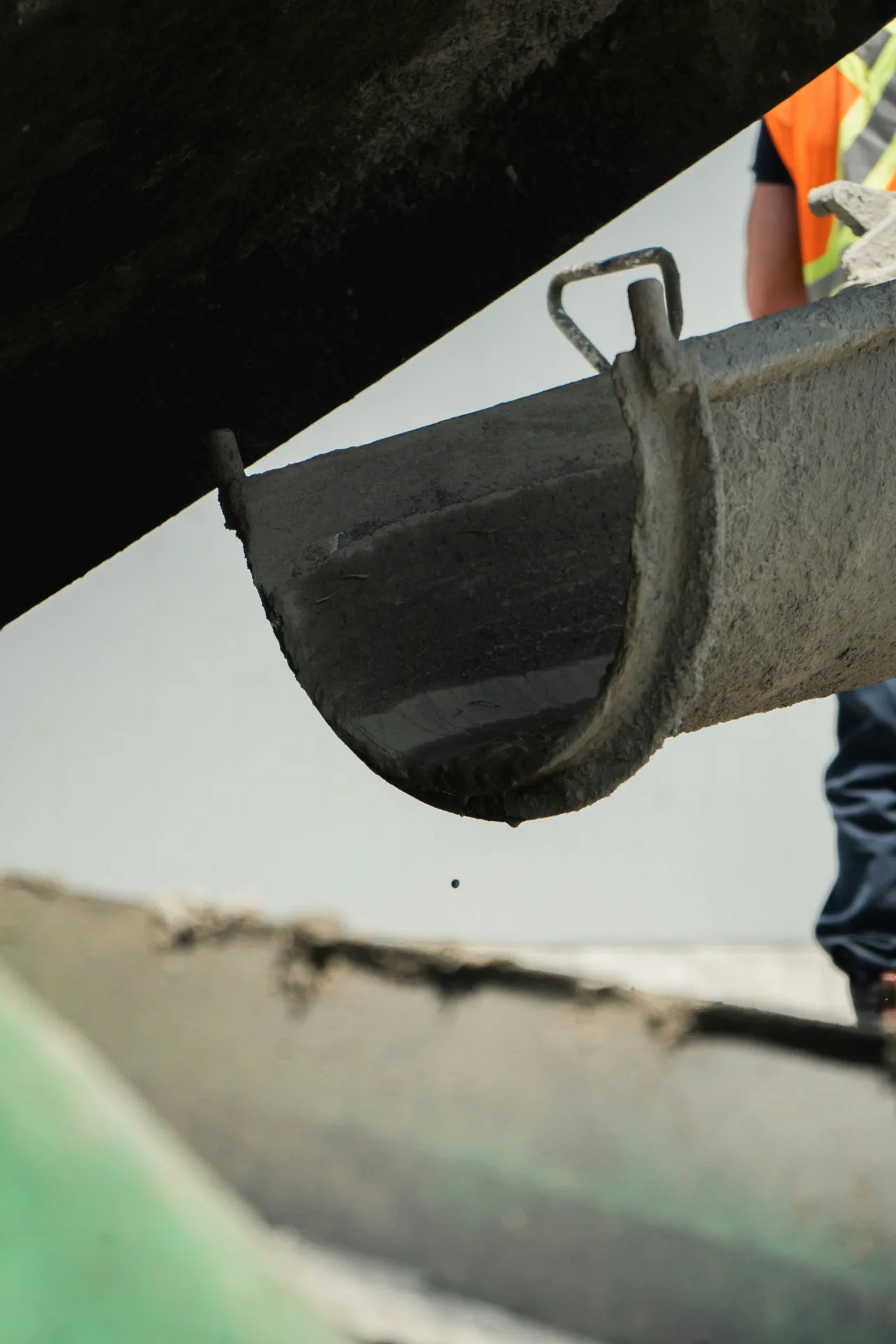 volumetric mixer discharging fresh concrete to placement