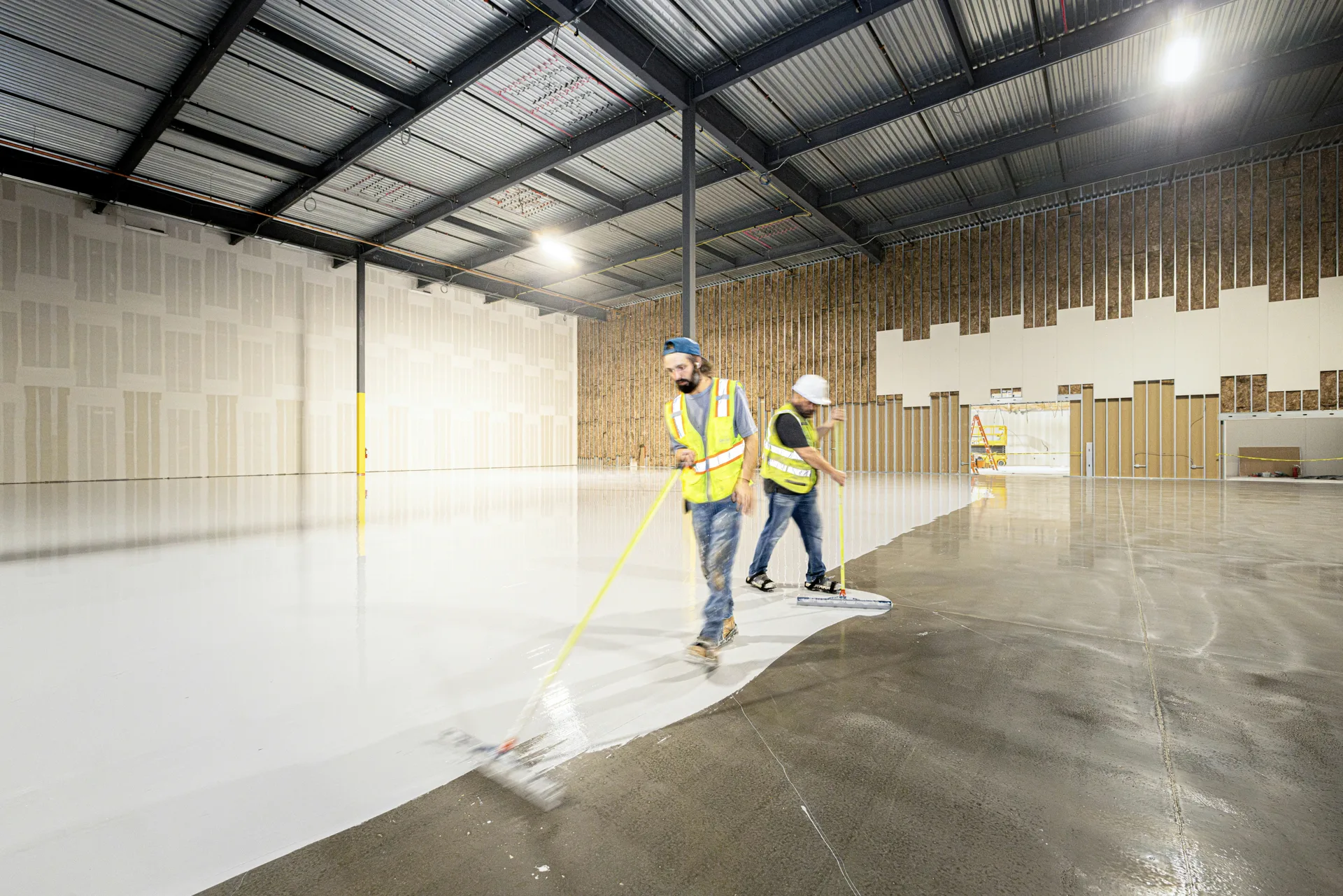 crew rolling epoxy onto a Abbotsford garage floor