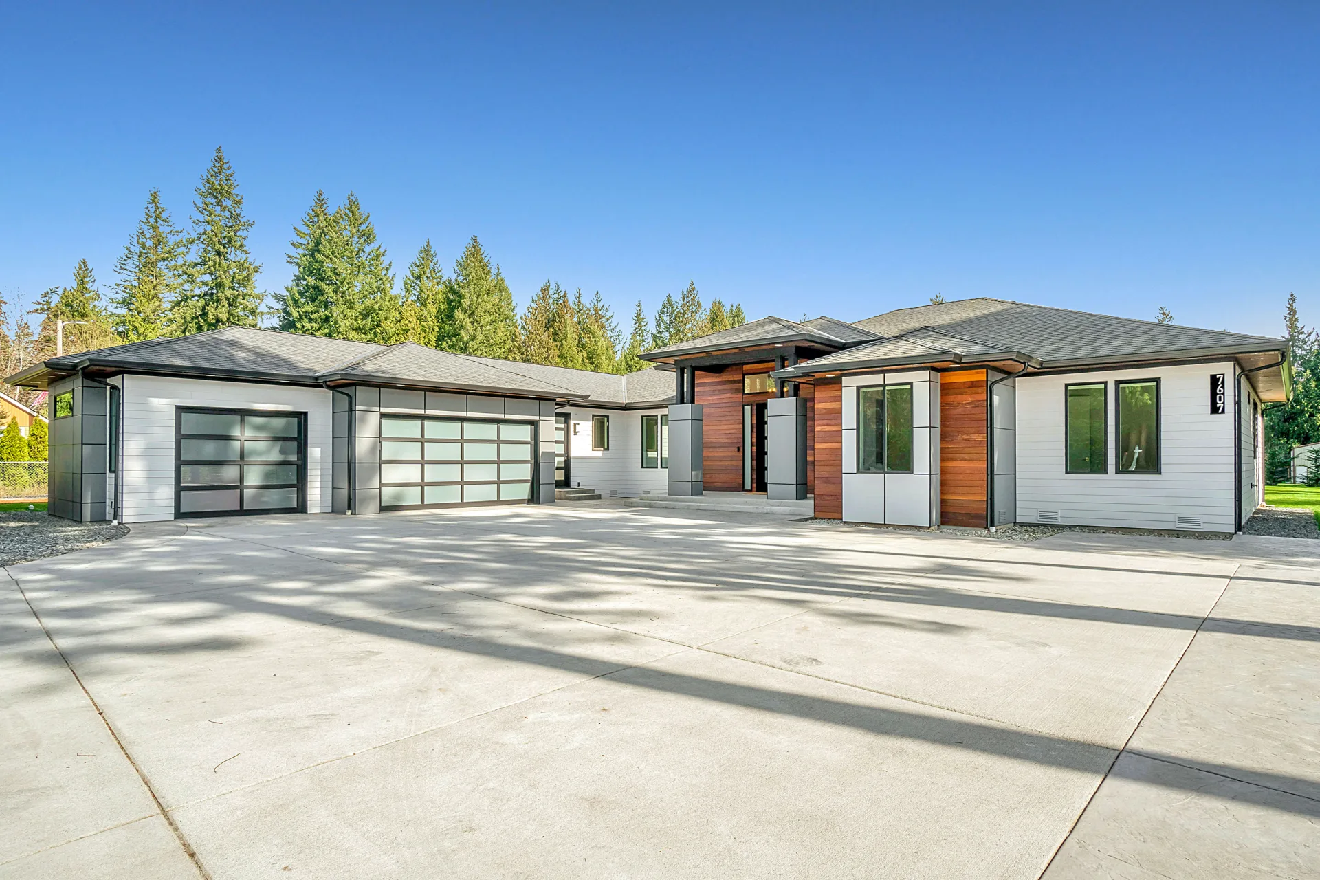 new concrete driveway at a modern three-car-garage Abbotsford home