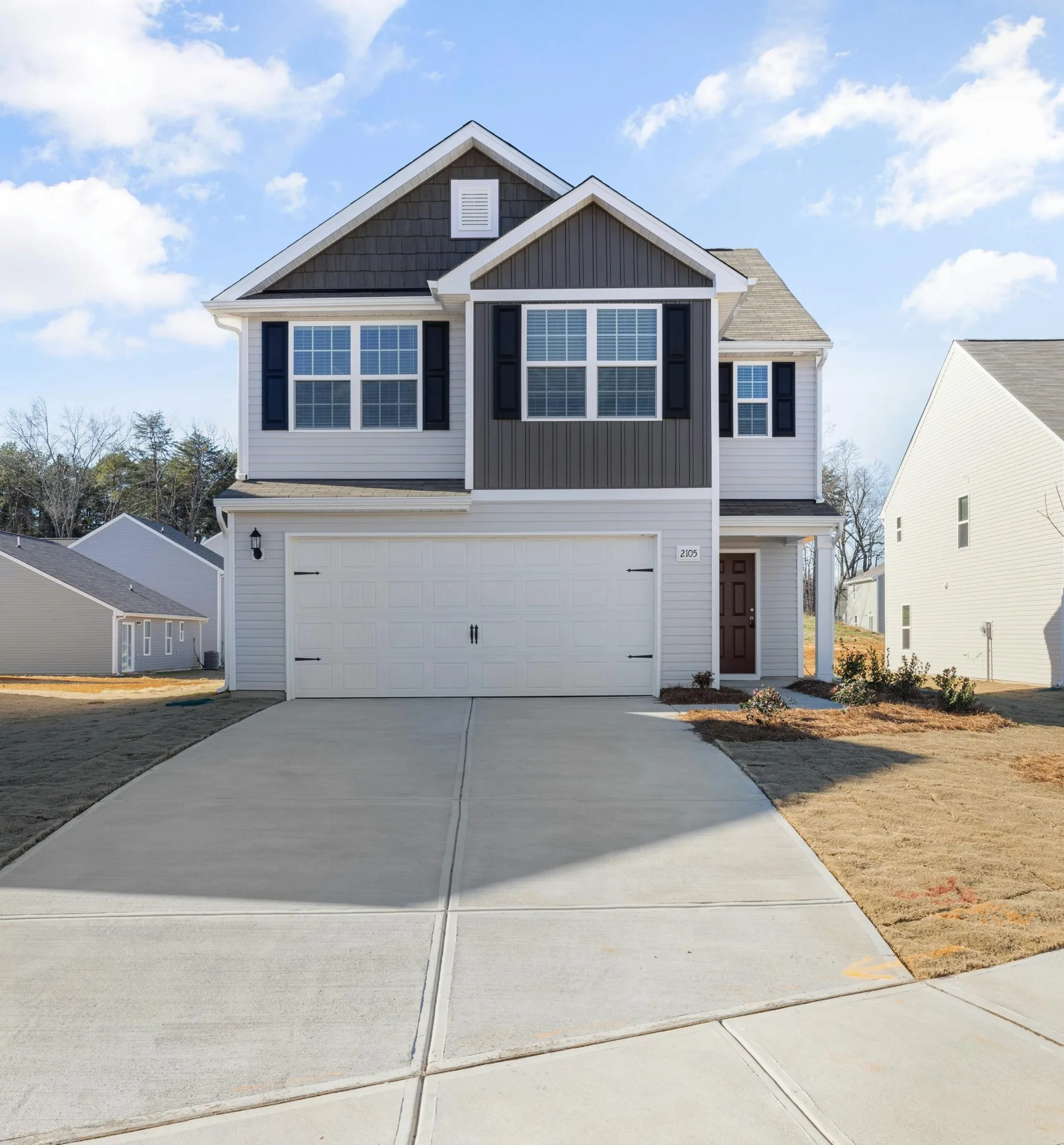 new concrete driveway at a grey new-build Abbotsford home