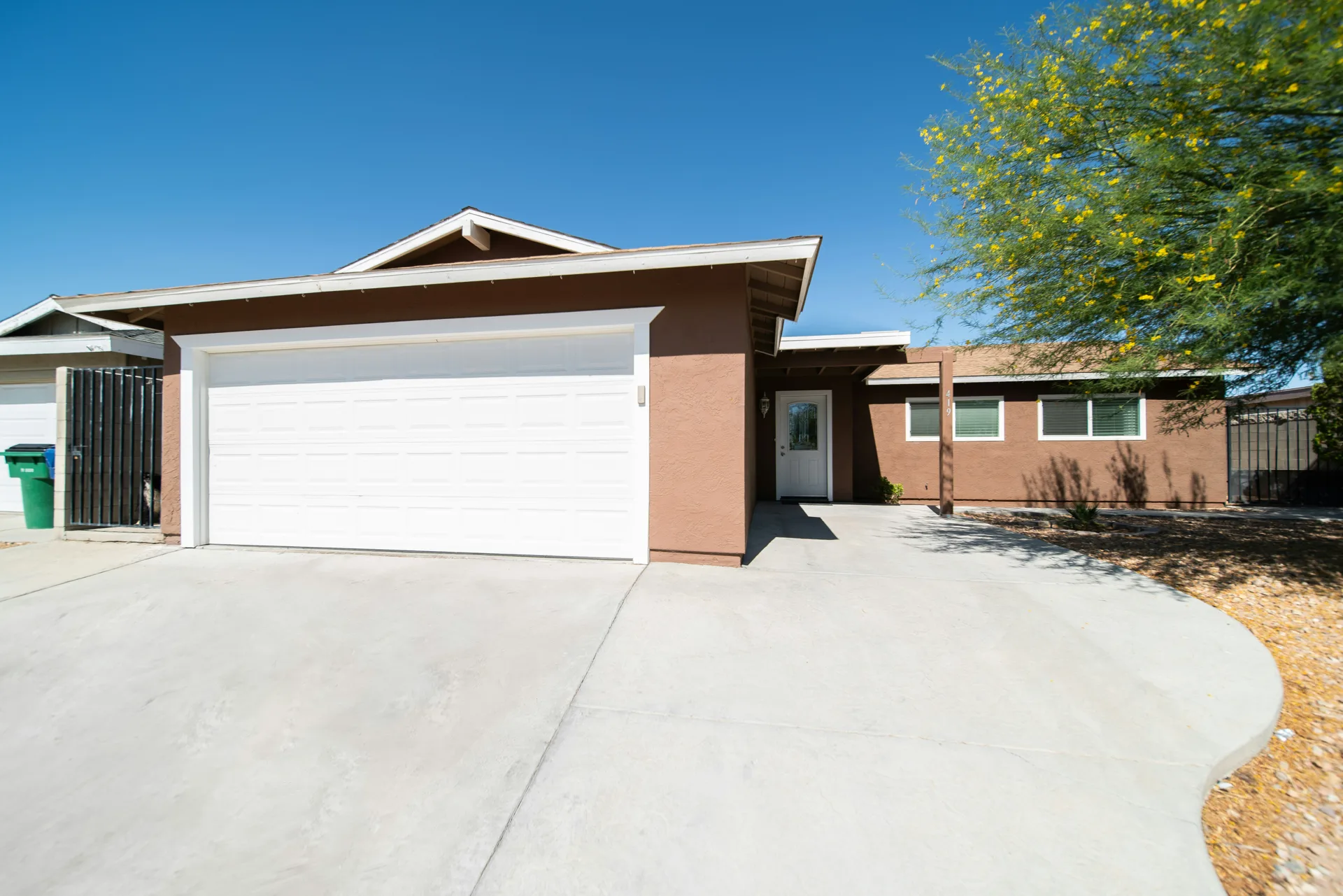 broom-finish concrete driveway at a Abbotsford stucco home