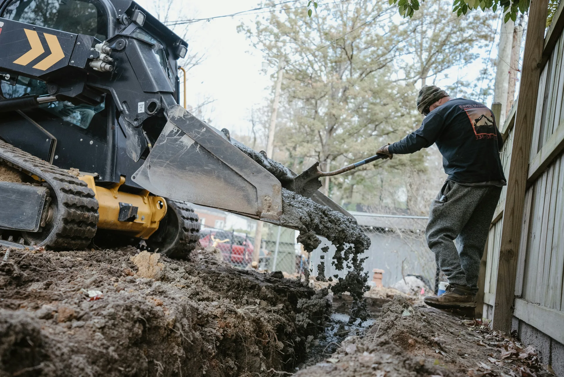 concrete foundation footing pour with a skid steer at a Abbotsford site