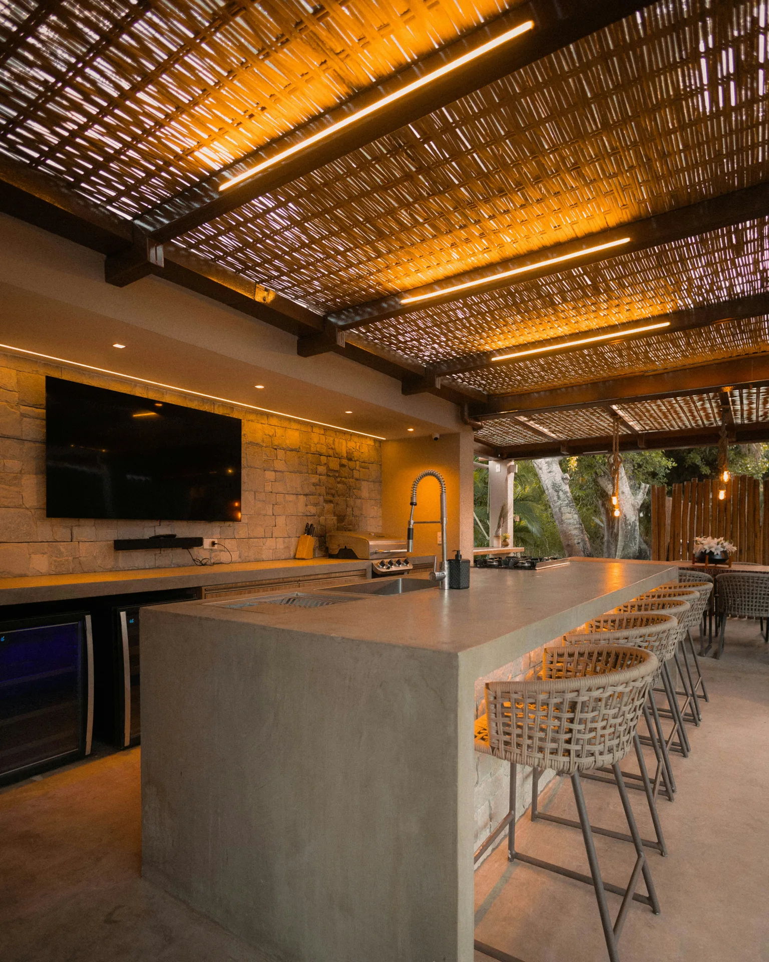 concrete outdoor kitchen bar under a pergola at a Abbotsford home